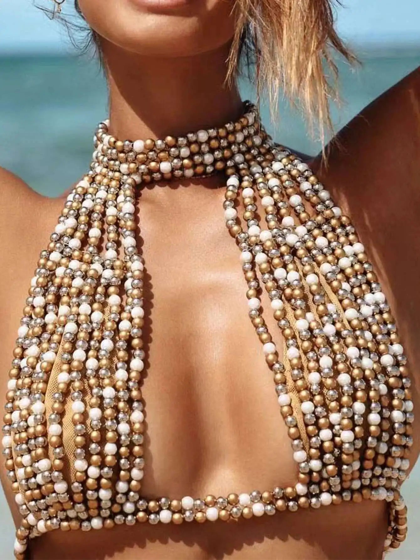 Top gioiello Oresha con perle decorative e design halter