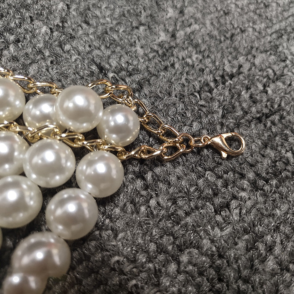 Top-scultura in perle Nyhg